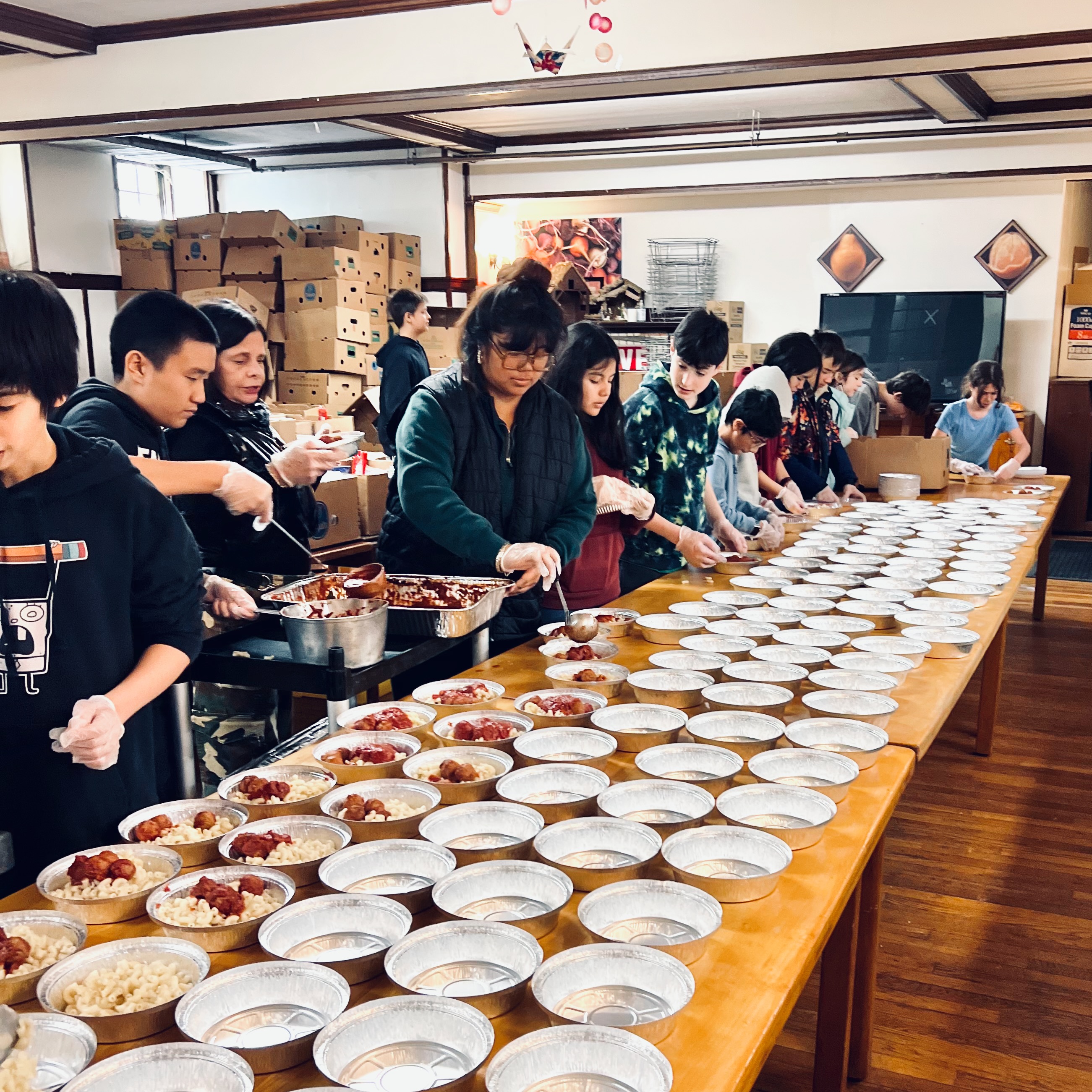 WSA students packing meals together at a community food pantry service project